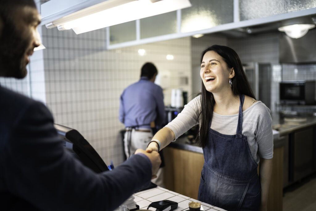 Lady in cafe shaking hands